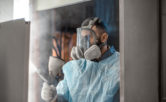 man in protective wear powder coating metal