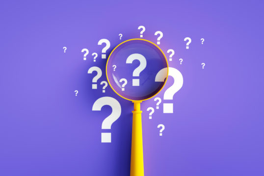 magnifier with question mark on purple background