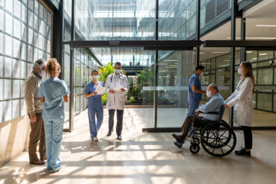 people walking in and out of the hospital