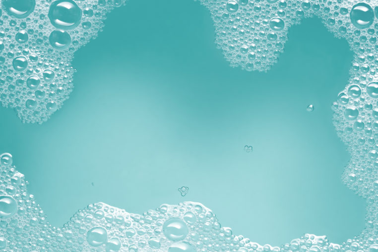 soap suds with water on turquoise background