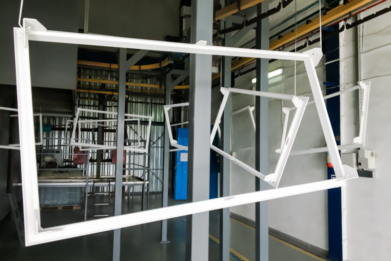 metal panels suspended on an overhead conveyor line