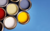 assortment of paint cans on blue background