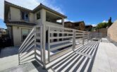 powder coated metal fence in the backyard of a two story house