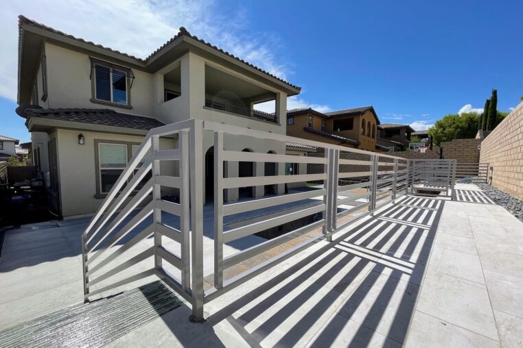 powder coated metal fence in the backyard of a two story house